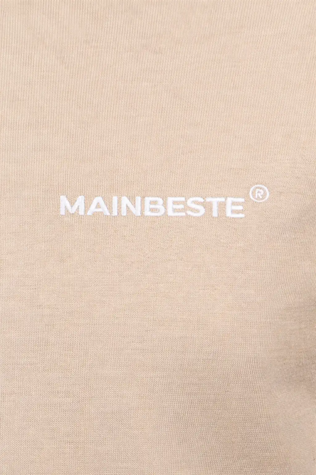 Close-up of embroidered Mainbeste logo on Sand Gold Hoodie
