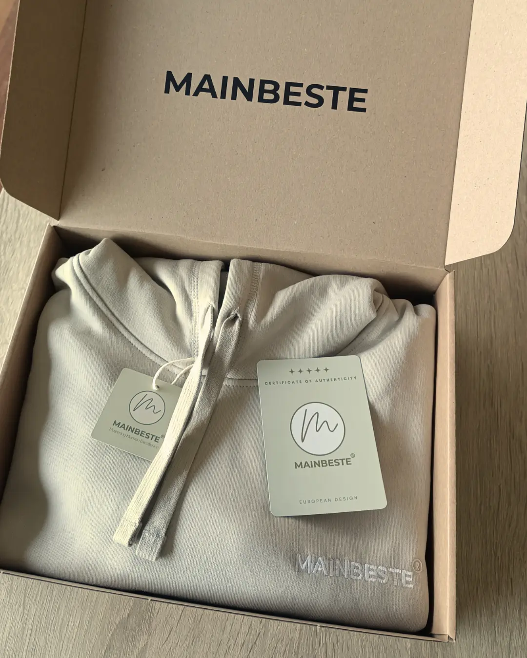 Mainbeste hoodie presented inside branded premium packaging